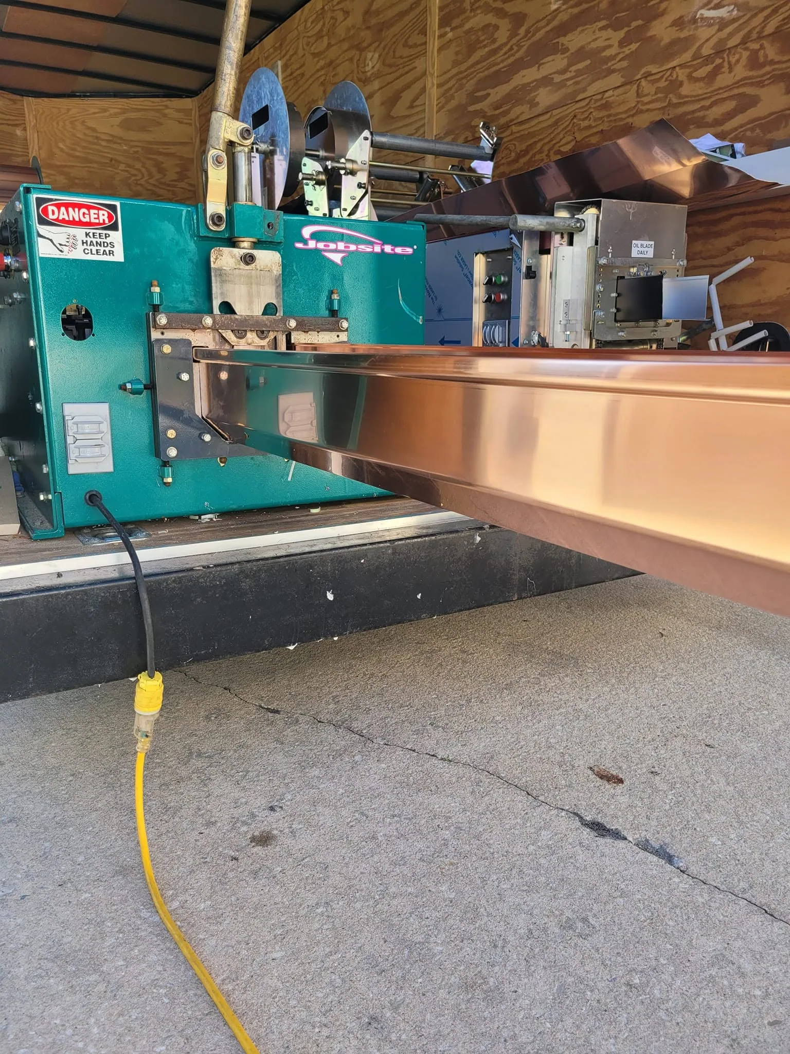 Copper seamless gutter machine trailer extrusion close up, Sanford